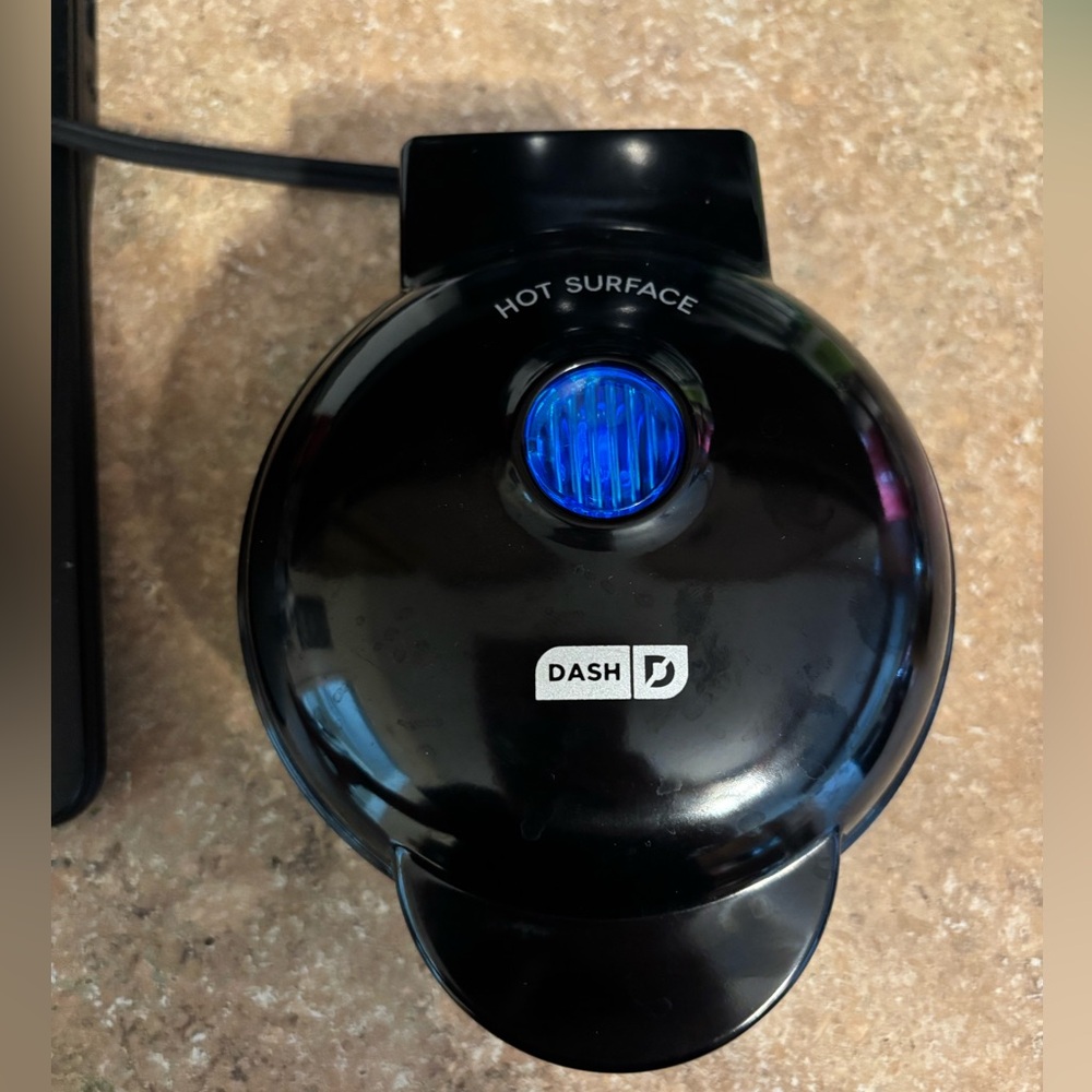 NIB mini dash waffle maker. it is black taken out of the box to show it works